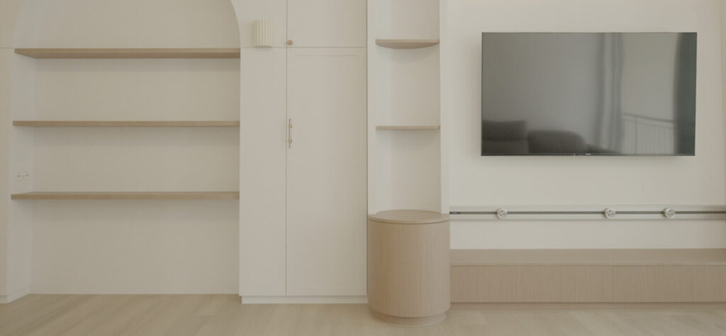 Minimalist living room with built-in shelves and a wall-mounted TV
