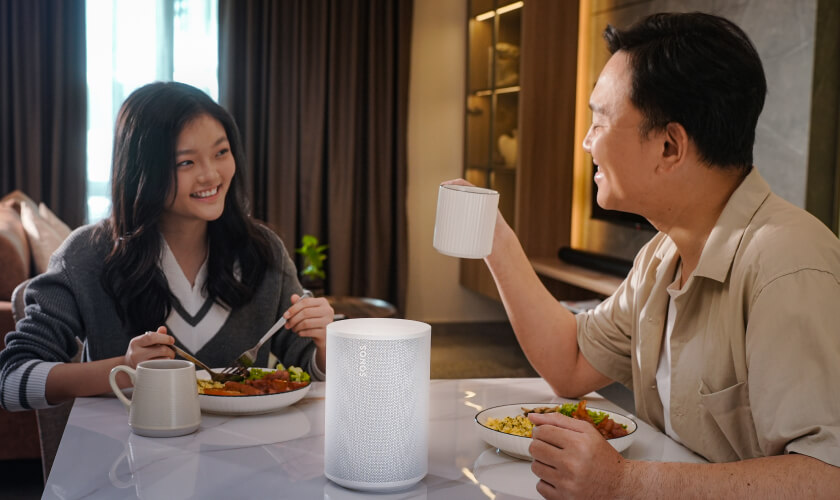 Modern dining area enhanced by a Sonos Era 100 speaker delivering warm, balanced sound.