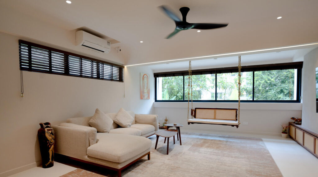 Tree Top Lounging living room with panoramic black-framed windows in a Potong Pasir HDB maisonette