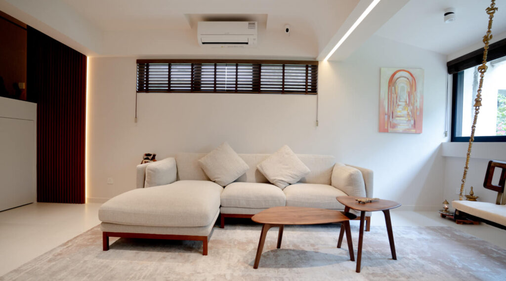 Low-profile sofa in a small HDB living room with panoramic windows
